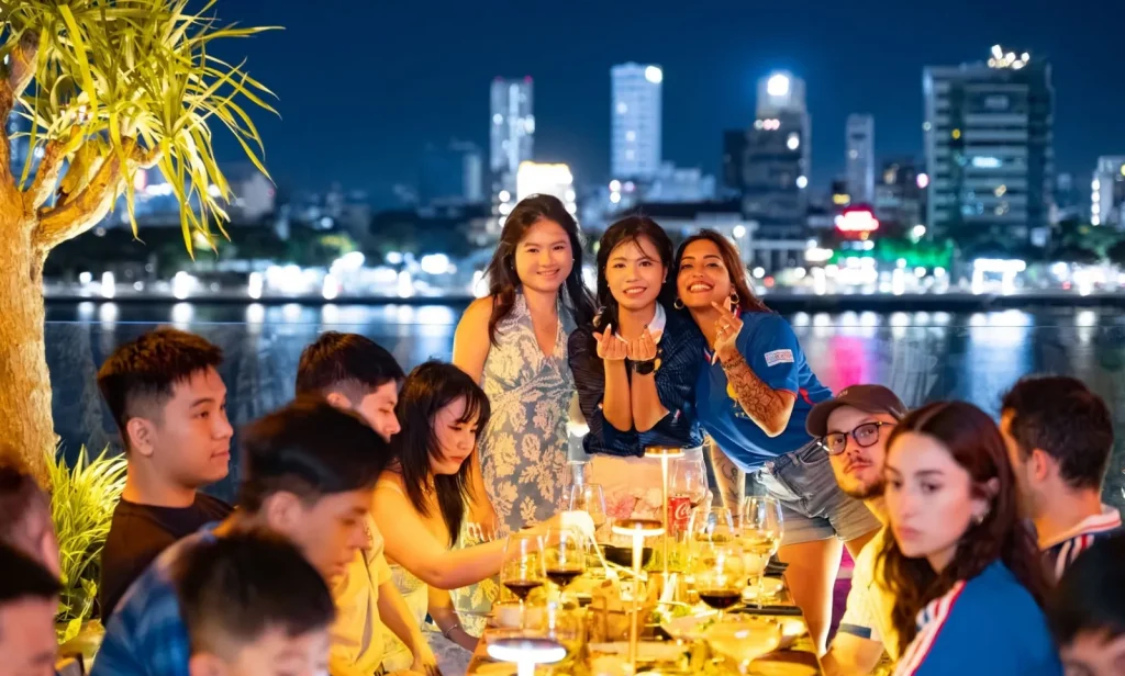 The Sutunam team at dinner, the city lights behind